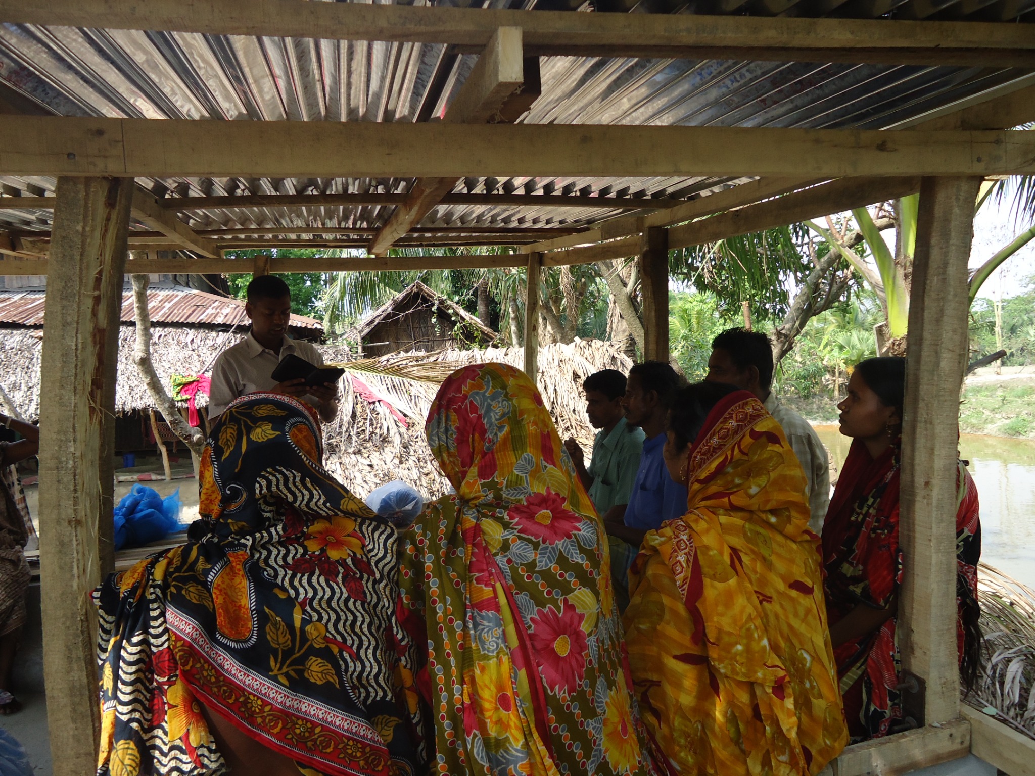 Community members gathered together with Christian materials