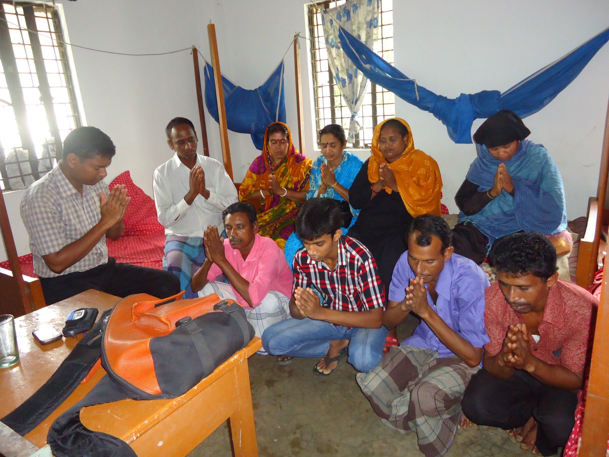 A community group gathered together in prayer