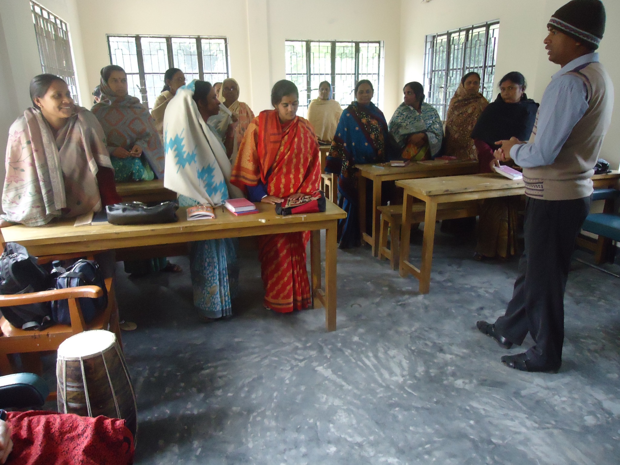 A group gathered for teaching and fellowship in a classroom