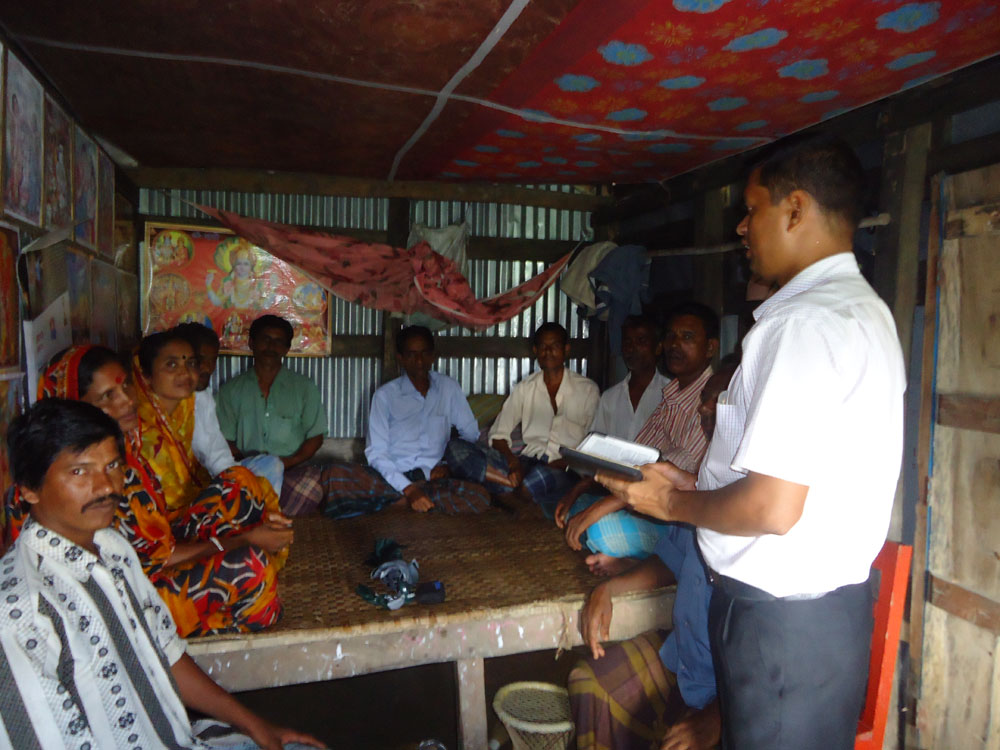 A small community gathering indoors for fellowship and teaching